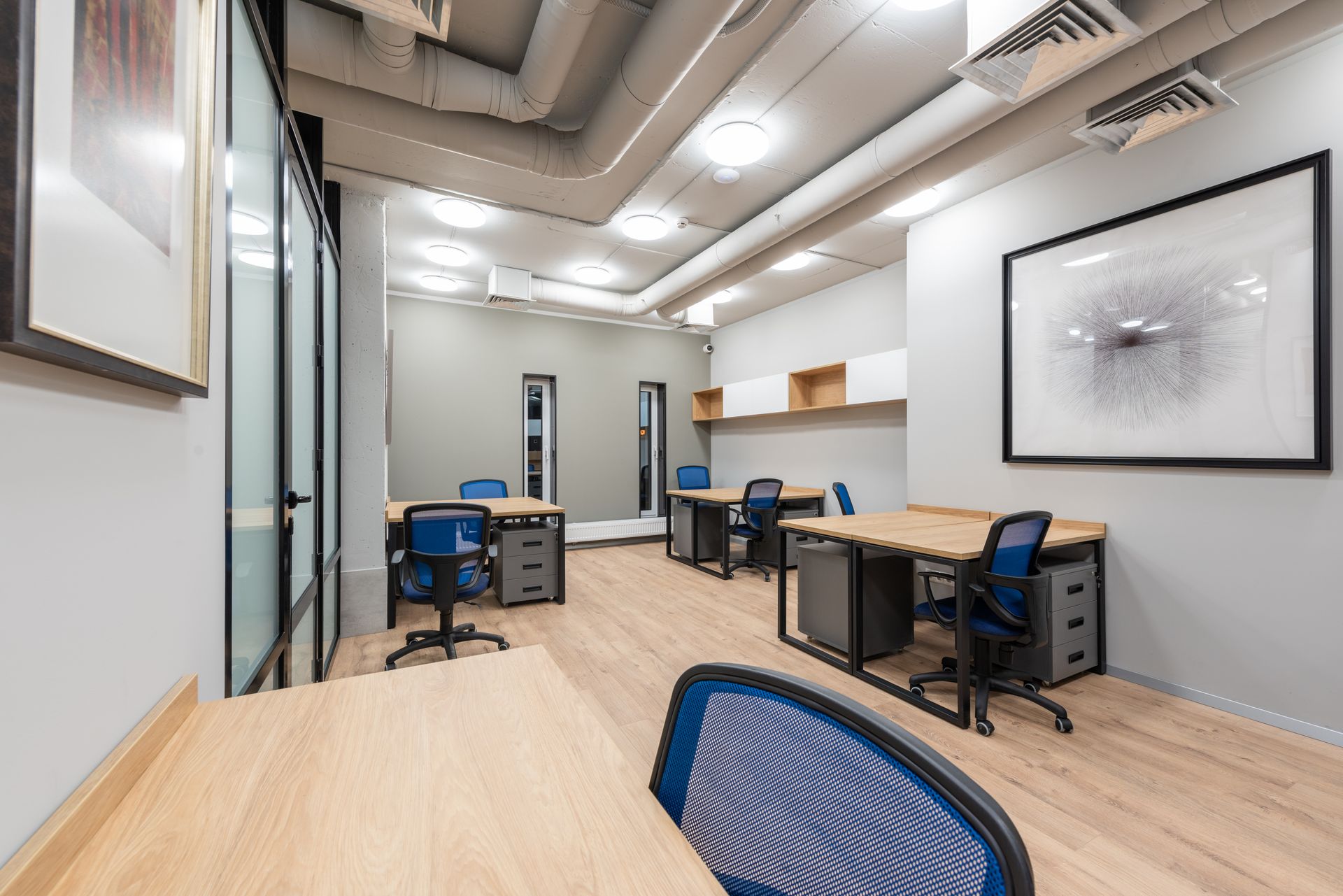 Modern office with desks and blue chairs