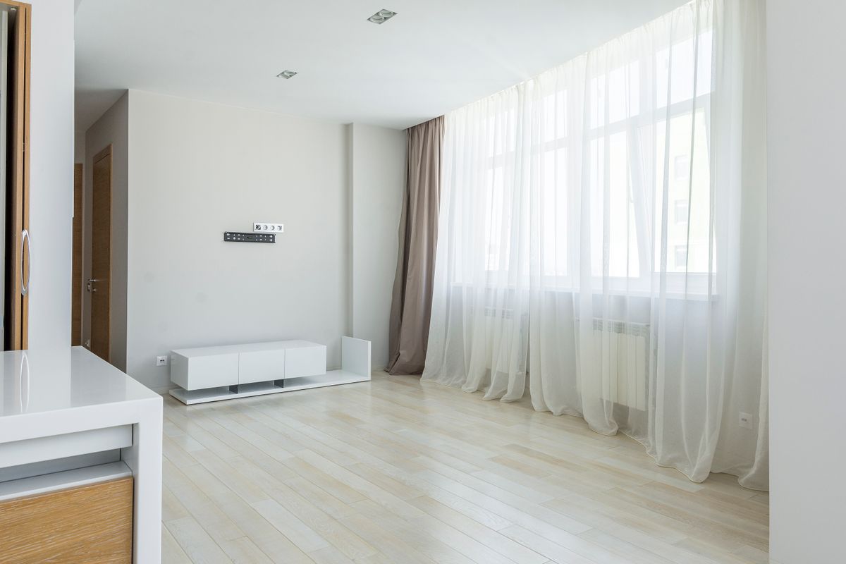 Clean empty apartment with bright windows and polished floors